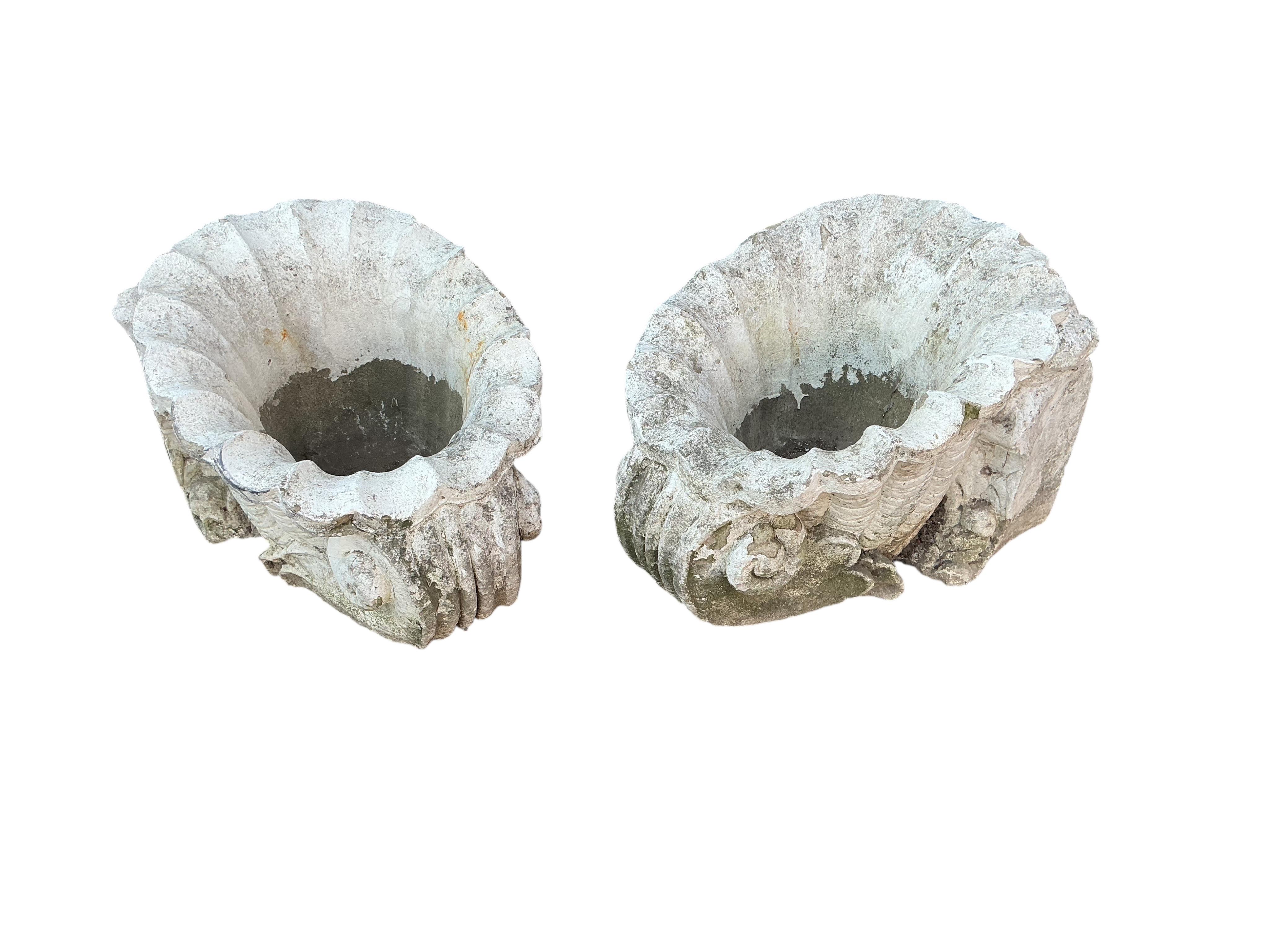 A pair of reconstituted shell style garden planters, width 39cm, height 32cm.